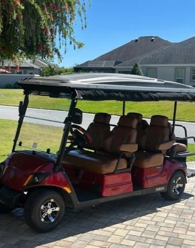 Red six-seat Yamaha limousine golf cart