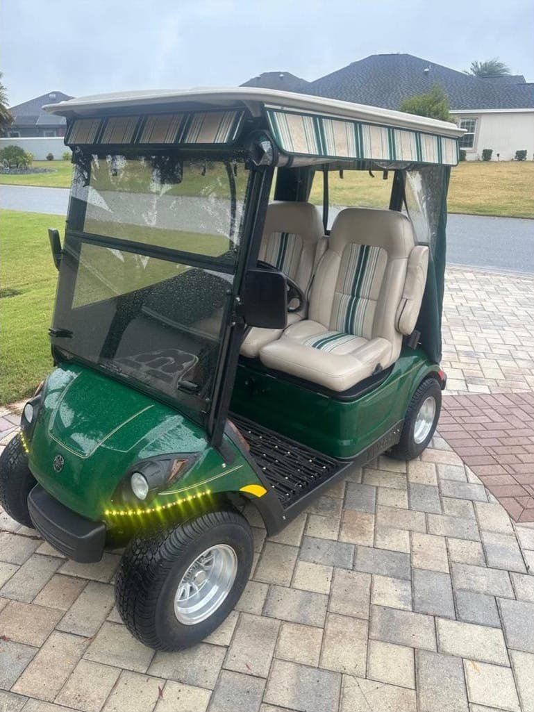 Green two-seat Yamaha golf cart